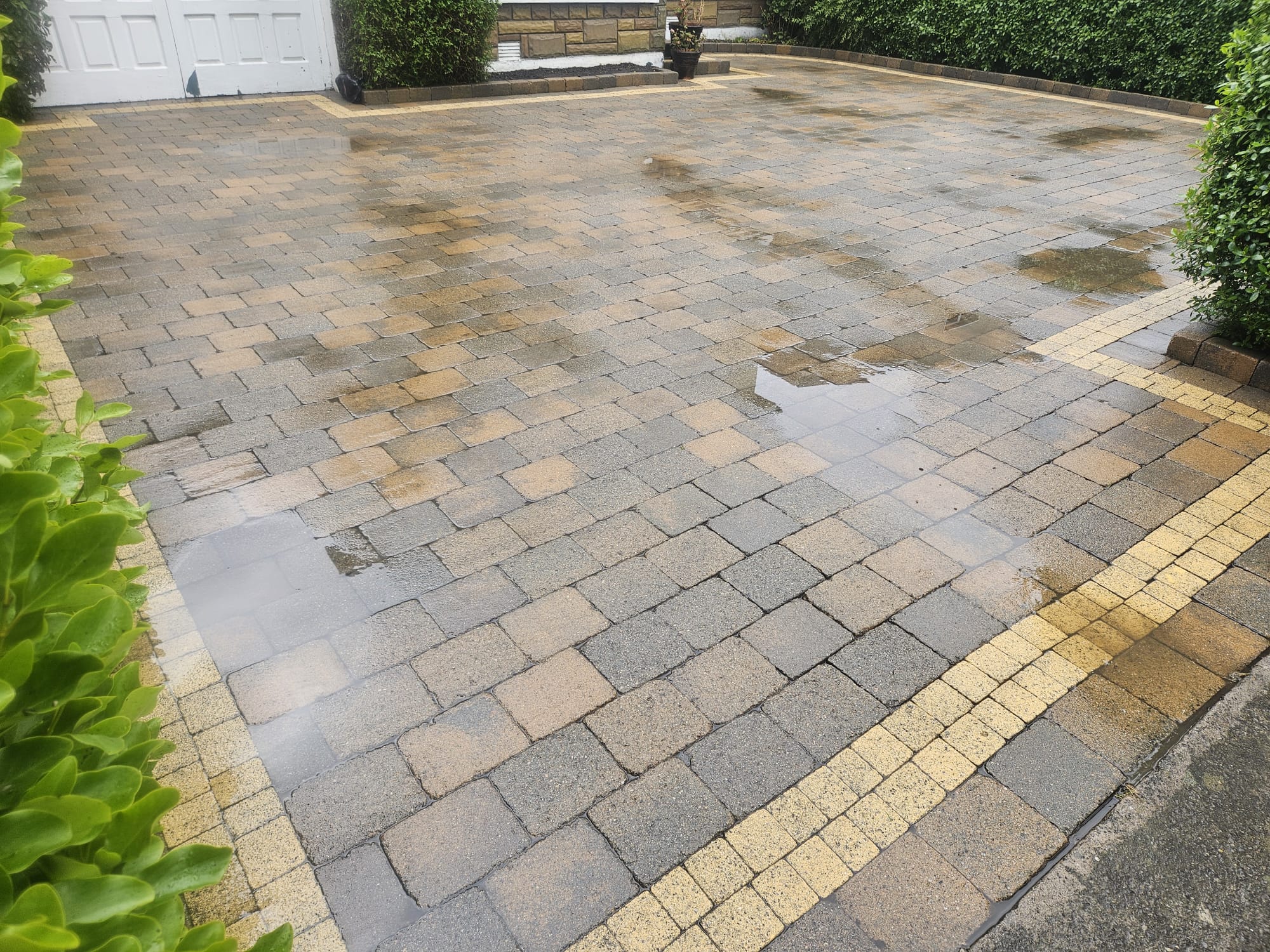 The same block paving driveway after cleaning — buff border and colour mix restored