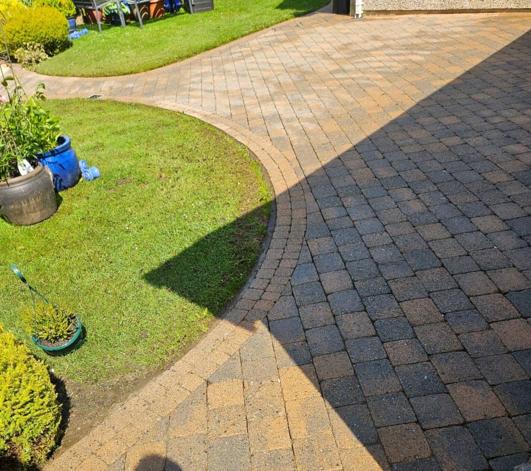 The same curved block paving driveway after cleaning, full colour mix restored
