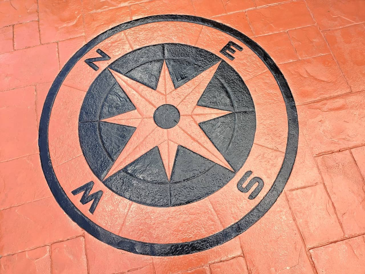 Imprinted concrete compass feature