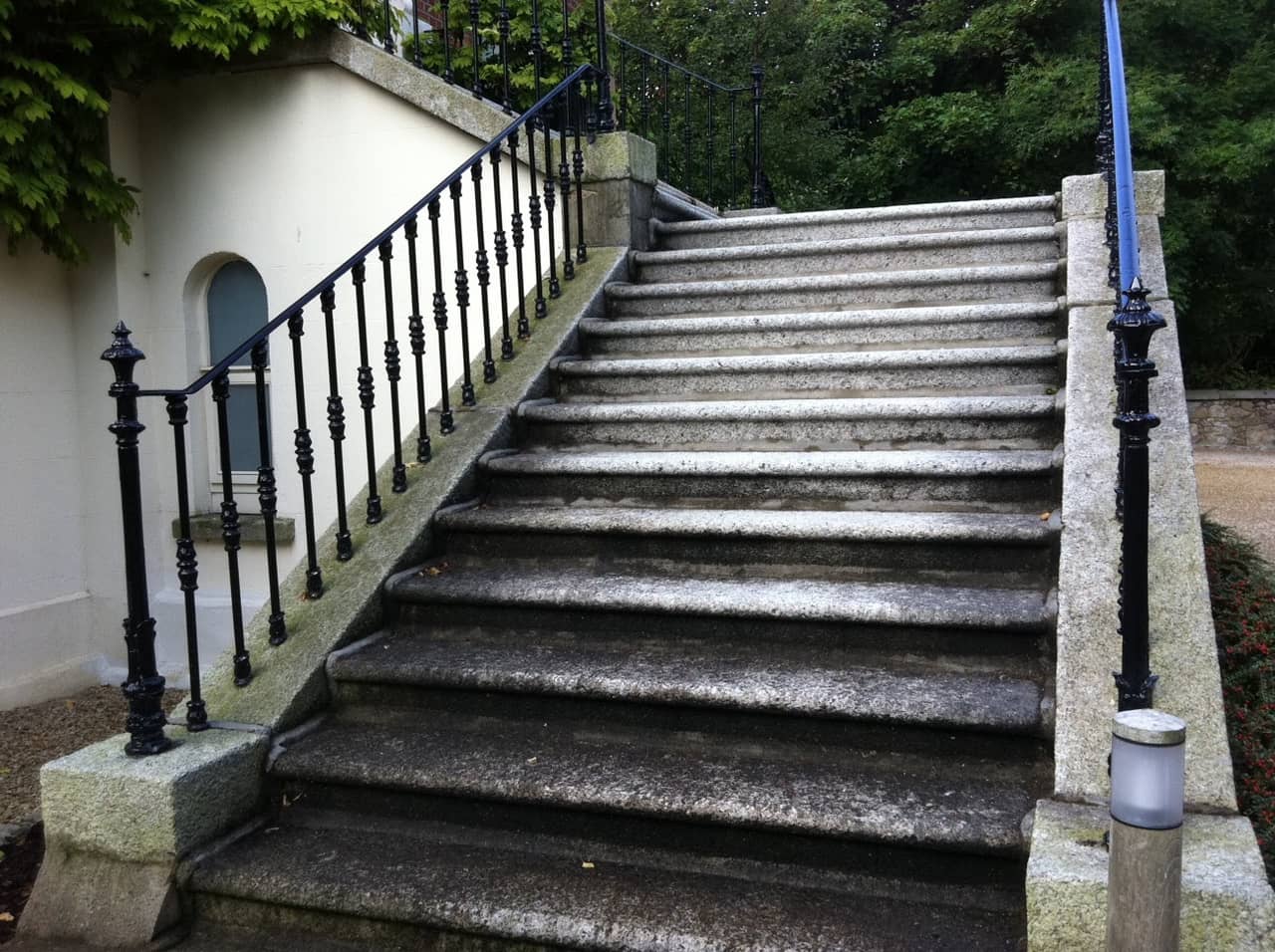 Granite steps before cleaning, heavily soiled and moss-covered