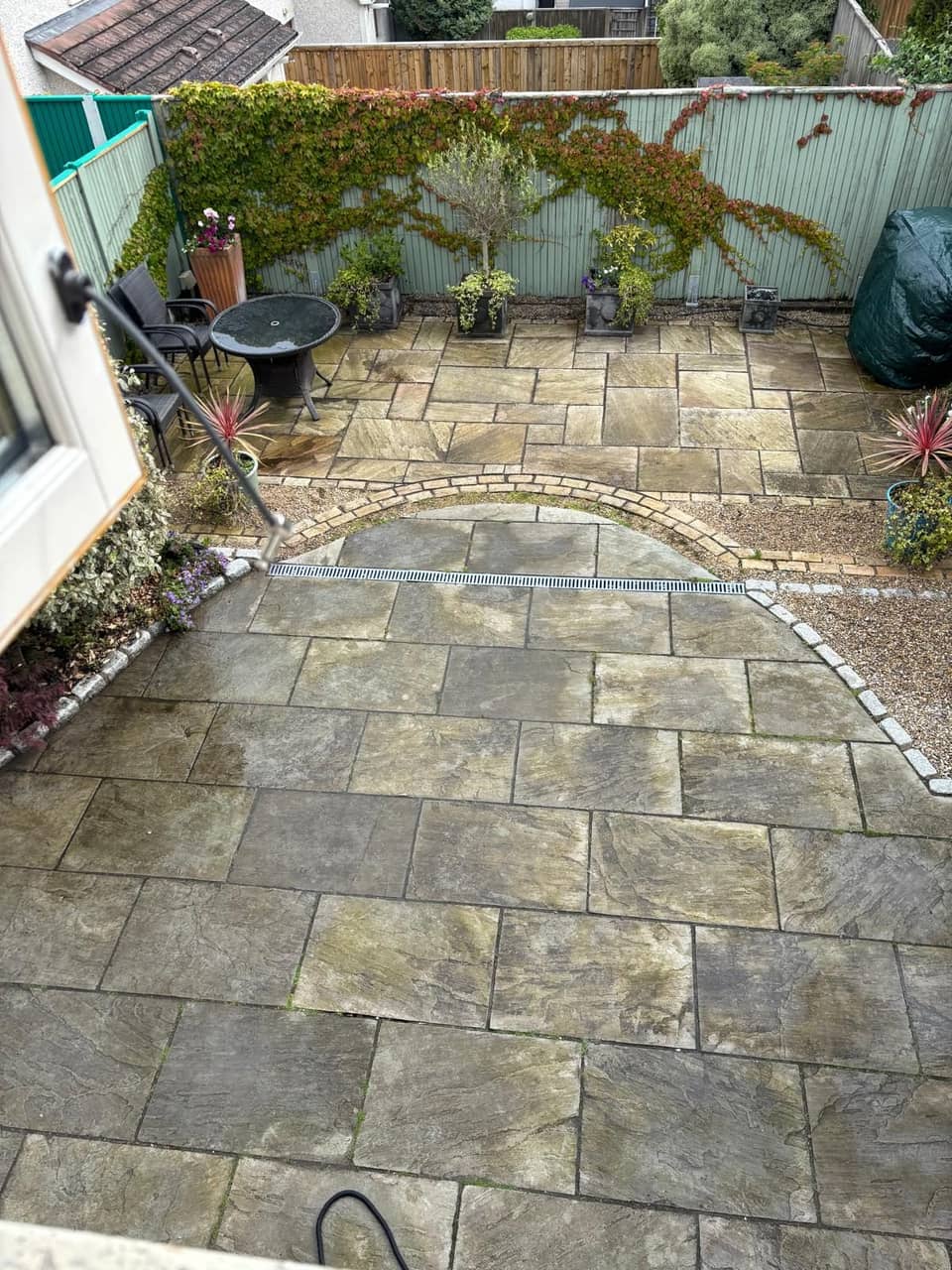 Curved sandstone patio before cleaning